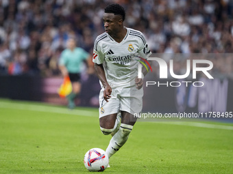 Vinicius Junior of Real Madrid CF is in action with the ball during the La Liga EA Sports 2024/25 football match between Real Madrid CF and...