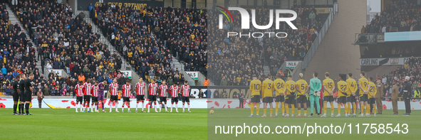 The officials and teams observe a minute's silence as they pay their respects to the fallen during the Premier League match between Wolverha...