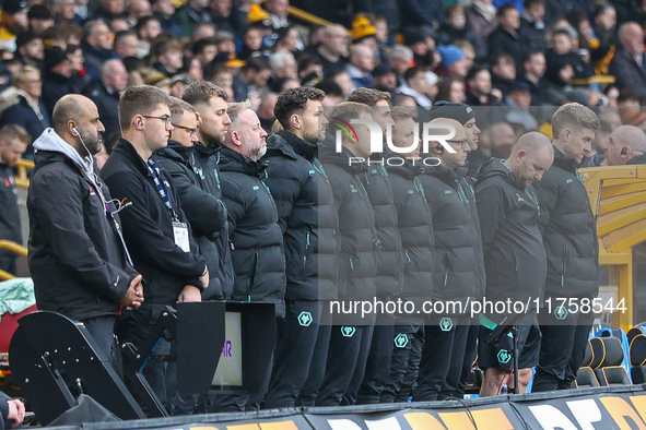 Wolves playing staff observe a minute's silence as they pay their respects to the fallen during the Premier League match between Wolverhampt...