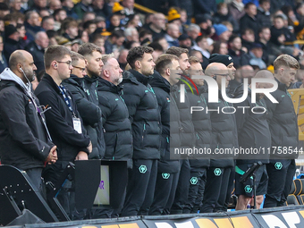 Wolves playing staff observe a minute's silence as they pay their respects to the fallen during the Premier League match between Wolverhampt...