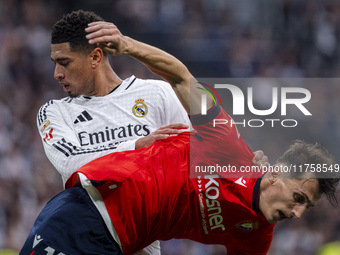 Jude Bellingham of Real Madrid CF (L) is in action against Ante Budimir of CA Osasuna (R) during the La Liga EA Sports 2024/25 football matc...