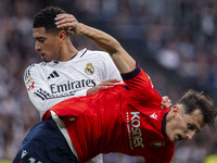 Jude Bellingham of Real Madrid CF (L) is in action against Ante Budimir of CA Osasuna (R) during the La Liga EA Sports 2024/25 football matc...