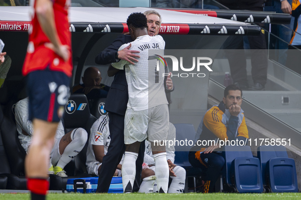 Vinicius Junior of Real Madrid CF hugs Carlo Ancelotti, head coach of Real Madrid CF, during the La Liga EA Sports 2024/25 football match be...