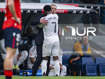 Vinicius Junior of Real Madrid CF hugs Carlo Ancelotti, head coach of Real Madrid CF, during the La Liga EA Sports 2024/25 football match be...