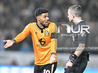 Elias Kachunga (10 Cambridge United) gestures to Referee Edward Duckworth during the Sky Bet League 1 match between Peterborough and Cambrid...