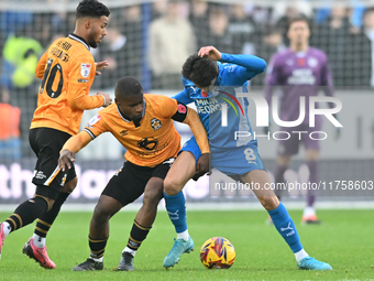 Brandon Njoku (34 Cambridge United) and Ryan De Havilland (8 Peterborough United) battle for the ball during the Sky Bet League 1 match betw...