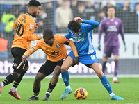 Brandon Njoku (34 Cambridge United) and Ryan De Havilland (8 Peterborough United) battle for the ball during the Sky Bet League 1 match betw...