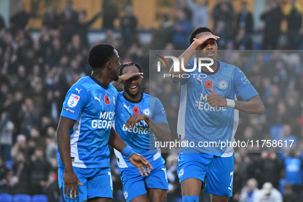 Malik Mothersille (7 Peterborough United) celebrates after scoring the team's fourth goal with Ricky Jade Jones in the center and Kwame Poku...