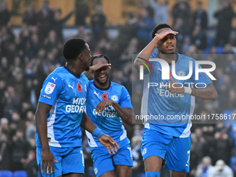 Malik Mothersille (7 Peterborough United) celebrates after scoring the team's fourth goal with Ricky Jade Jones in the center and Kwame Poku...