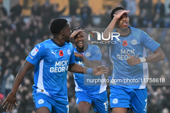 Malik Mothersille (7 Peterborough United) celebrates after scoring the team's fourth goal with Ricky Jade Jones in the center and Kwame Poku...