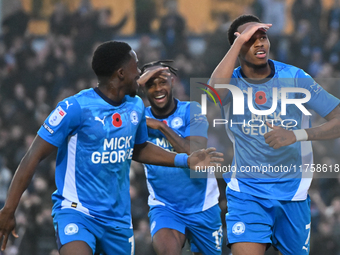 Malik Mothersille (7 Peterborough United) celebrates after scoring the team's fourth goal with Ricky Jade Jones in the center and Kwame Poku...