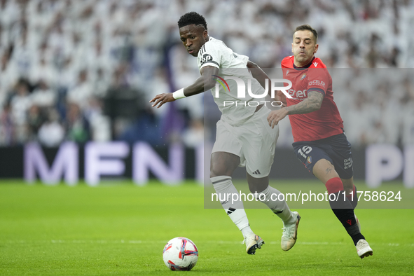 Vinicius Junior left winger of Real Madrid and Brazil and Ruben Peña right-back of Osasuna and Spain compete for the ball during the La Liga...