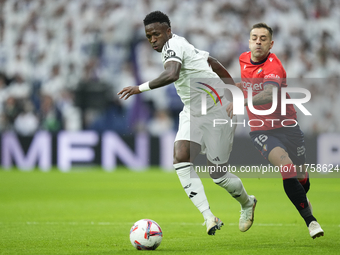 Vinicius Junior left winger of Real Madrid and Brazil and Ruben Peña right-back of Osasuna and Spain compete for the ball during the La Liga...