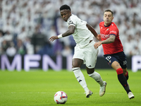 Vinicius Junior left winger of Real Madrid and Brazil and Ruben Peña right-back of Osasuna and Spain compete for the ball during the La Liga...