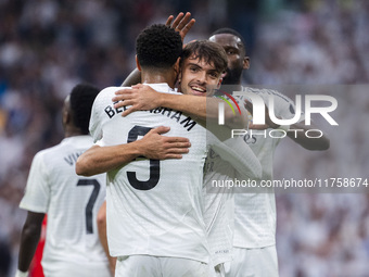 Jude Bellingham of Real Madrid CF celebrates his goal by hugging Raul Asencio of Real Madrid CF during the La Liga EA Sports 2024/25 footbal...