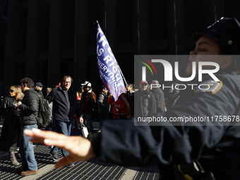 Trump supporters participate in the immigrant protest over imminent changes to immigration reforms in Manhattan, NY, on November 9, 2024. Th...