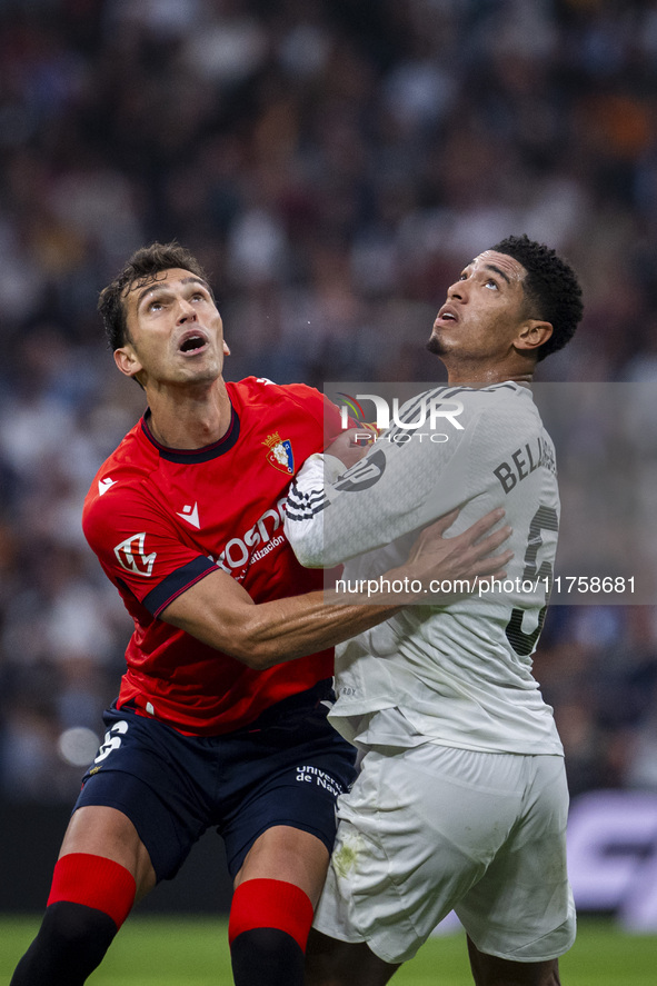 Jude Bellingham of Real Madrid CF (R) is in action against Lucas Torro of CA Osasuna (L) during the La Liga EA Sports 2024/25 football match...