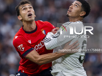 Jude Bellingham of Real Madrid CF (R) is in action against Lucas Torro of CA Osasuna (L) during the La Liga EA Sports 2024/25 football match...