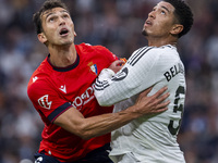 Jude Bellingham of Real Madrid CF (R) is in action against Lucas Torro of CA Osasuna (L) during the La Liga EA Sports 2024/25 football match...