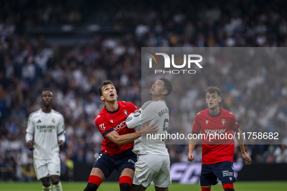 Jude Bellingham of Real Madrid CF (R) is in action against Lucas Torro of CA Osasuna (L) during the La Liga EA Sports 2024/25 football match...