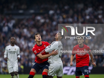 Jude Bellingham of Real Madrid CF (R) is in action against Lucas Torro of CA Osasuna (L) during the La Liga EA Sports 2024/25 football match...