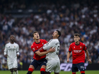 Jude Bellingham of Real Madrid CF (R) is in action against Lucas Torro of CA Osasuna (L) during the La Liga EA Sports 2024/25 football match...