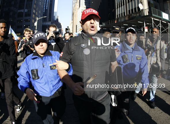 Trump supporters participate in the immigrant protest over imminent changes to immigration reforms in Manhattan, NY, on November 9, 2024. Th...