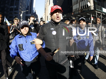 Trump supporters participate in the immigrant protest over imminent changes to immigration reforms in Manhattan, NY, on November 9, 2024. Th...