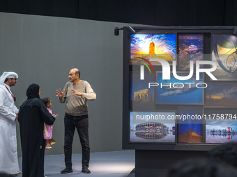 People look at photographs on display during the inaugural Doha Photography Festival 2024 at Darb al-Saai in Umm Salal, Qatar, on November 8...