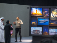 People look at photographs on display during the inaugural Doha Photography Festival 2024 at Darb al-Saai in Umm Salal, Qatar, on November 8...