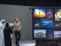 People look at photographs on display during the inaugural Doha Photography Festival 2024 at Darb al-Saai in Umm Salal, Qatar, on November 8...