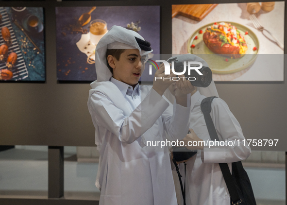 Two young Qatari boys look into the camera during the inaugural Doha Photography Festival 2024 at Darb al-Saai in Umm Salal, Qatar, on Novem...