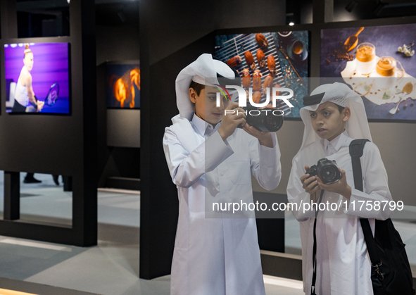 Two young Qatari boys look into the camera during the inaugural Doha Photography Festival 2024 at Darb al-Saai in Umm Salal, Qatar, on Novem...