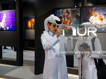 Two young Qatari boys look into the camera during the inaugural Doha Photography Festival 2024 at Darb al-Saai in Umm Salal, Qatar, on Novem...