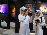 Two young Qatari boys look into the camera during the inaugural Doha Photography Festival 2024 at Darb al-Saai in Umm Salal, Qatar, on Novem...