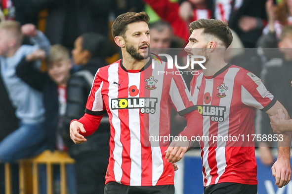 #10, Adam Lallana, and #3, Ryan Manning of Southampton participate in the Premier League match between Wolverhampton Wanderers and Southampt...