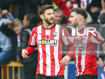 #10, Adam Lallana, and #3, Ryan Manning of Southampton participate in the Premier League match between Wolverhampton Wanderers and Southampt...