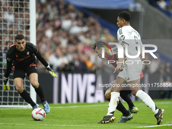 Jude Bellingham central midfield of Real Madrid and England and Ante Budimir centre-forward of Osasuna and Croatia compete for the ball duri...