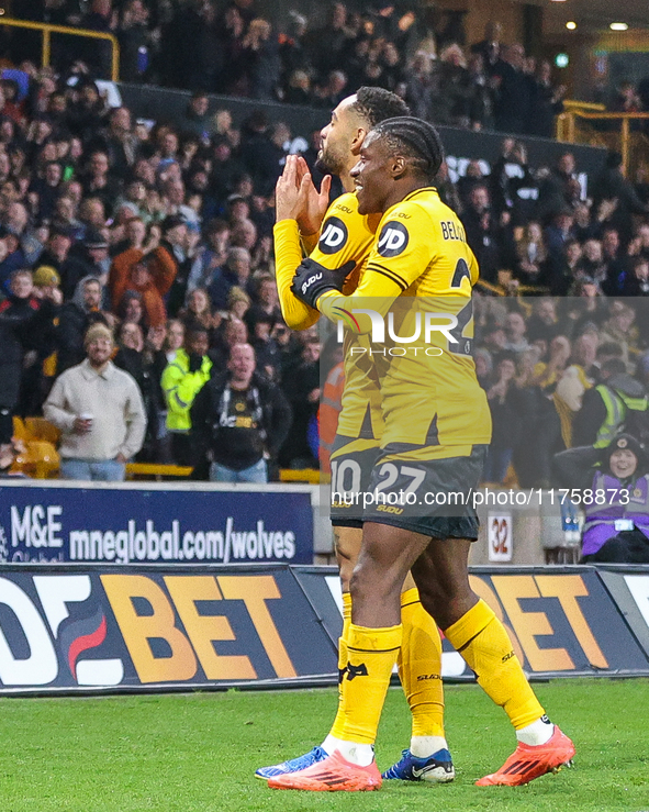 #27, Jean-Ricner Bellegarde of Wolves congratulates goal scorer, #10, Matheus Cunha during the Premier League match between Wolverhampton Wa...