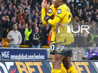 #27, Jean-Ricner Bellegarde of Wolves congratulates goal scorer, #10, Matheus Cunha during the Premier League match between Wolverhampton Wa...