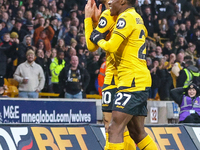 #27, Jean-Ricner Bellegarde of Wolves congratulates goal scorer, #10, Matheus Cunha during the Premier League match between Wolverhampton Wa...