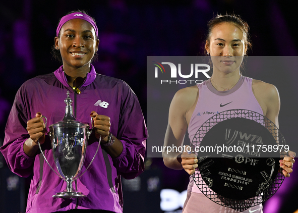 RIYADH, SAUDI ARABIA - NOVEMBER 09: Coco Gauff of USA and Quinwen Zheng of China pose for a photo with their Trophy after the Final, on Day...