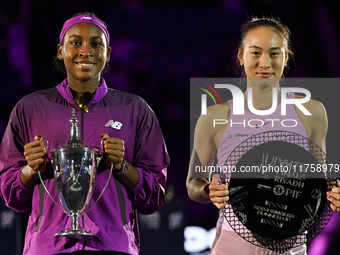 RIYADH, SAUDI ARABIA - NOVEMBER 09: Coco Gauff of USA and Quinwen Zheng of China pose for a photo with their Trophy after the Final, on Day...