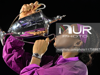 RIYADH, SAUDI ARABIA - NOVEMBER 09: Coco Gauff of USA celebrates with the Official Trophy after winning the Final match against Quinwen Zhen...