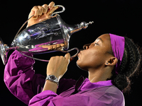 RIYADH, SAUDI ARABIA - NOVEMBER 09: Coco Gauff of USA celebrates with the Official Trophy after winning the Final match against Quinwen Zhen...