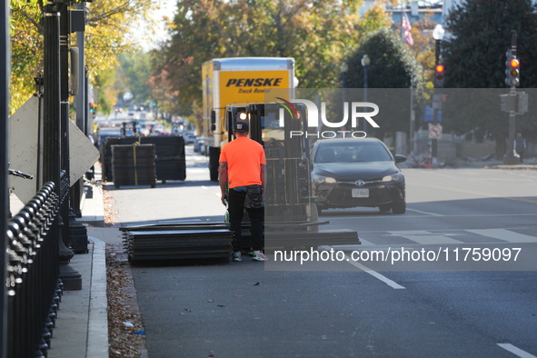 Security officials remove riot fences from around the White House complex in Washington, D.C., United States, on November 9, 2024. The fence...