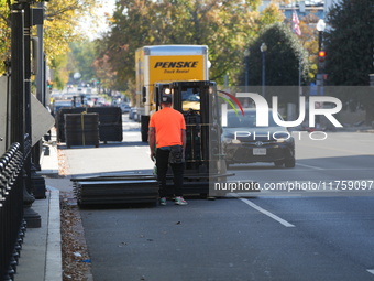 Security officials remove riot fences from around the White House complex in Washington, D.C., United States, on November 9, 2024. The fence...