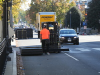 Security officials remove riot fences from around the White House complex in Washington, D.C., United States, on November 9, 2024. The fence...