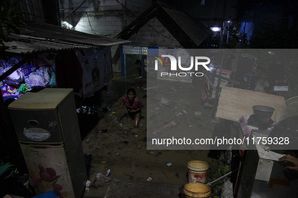 Residents on the riverbanks flee to higher ground when their settlements flood due to the overflow of the Cikeas River after heavy rain for...