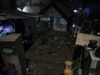 Residents on the riverbanks flee to higher ground when their settlements flood due to the overflow of the Cikeas River after heavy rain for...